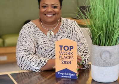 Dr. Sandra Braham poses with Gulf Coast JFCS Top Workplace Award