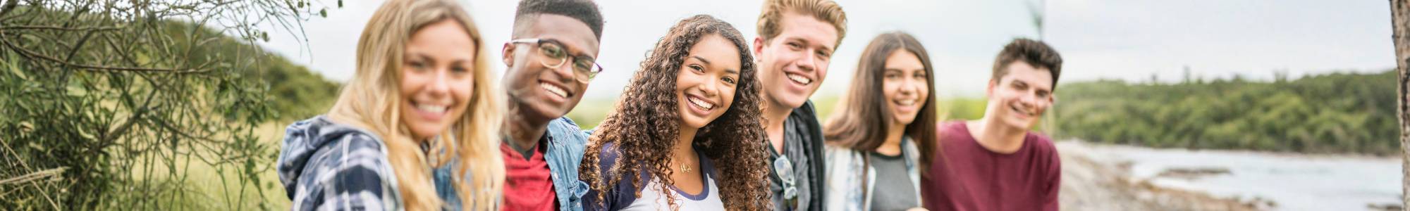 diverse group of children on grass happy
