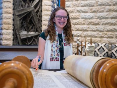 Teen stands smiling with backpack